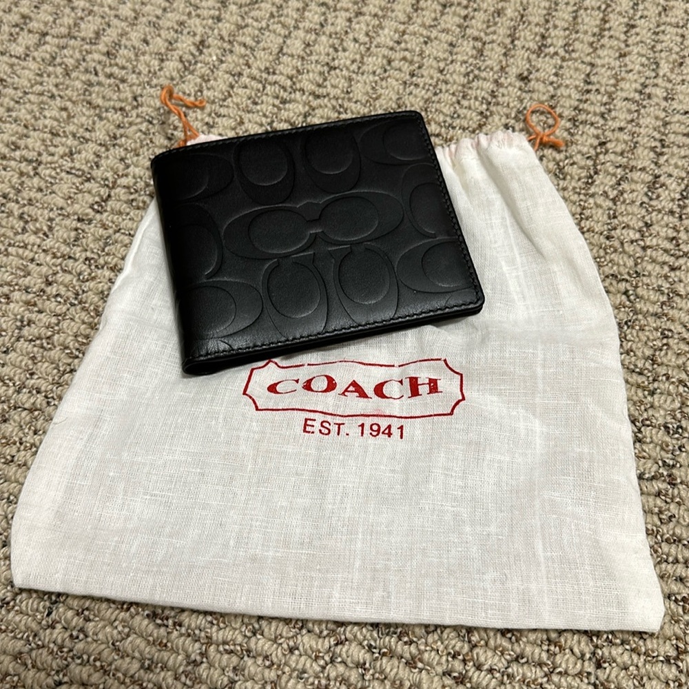 Men’s Coach. Brand new. Never used. Black leather large double billfold wallet.